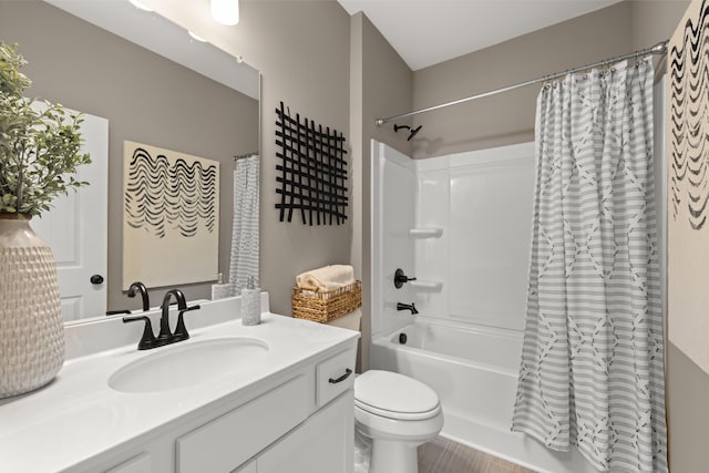 full bathroom featuring vanity, shower / bathtub combination with curtain, and toilet