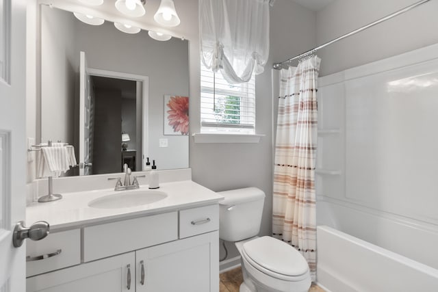 full bathroom with vanity, toilet, and shower / tub combo