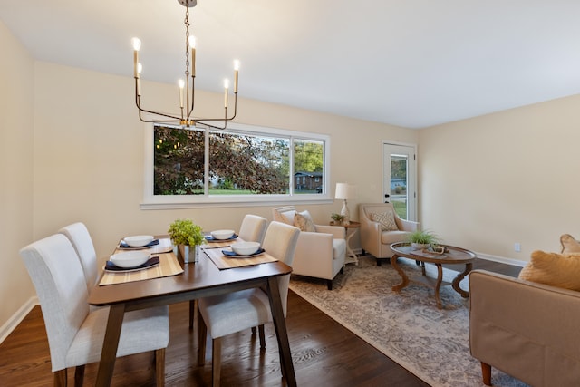 dining area with a chandelier and dark hardwood / wood-style floors