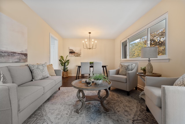 living room with dark hardwood / wood-style flooring and a chandelier