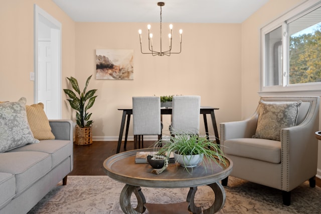 living room with a chandelier and dark wood-type flooring