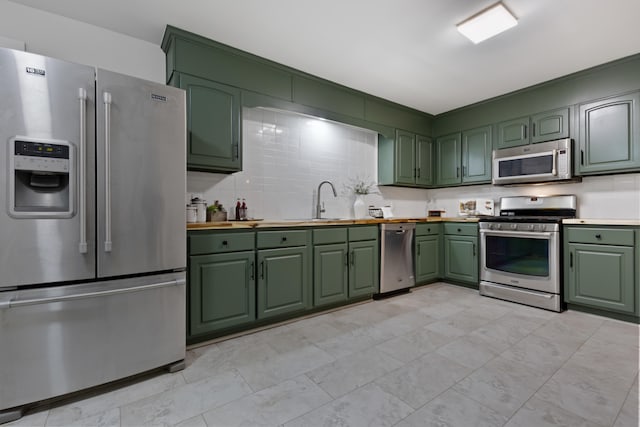 kitchen featuring sink, appliances with stainless steel finishes, and tasteful backsplash