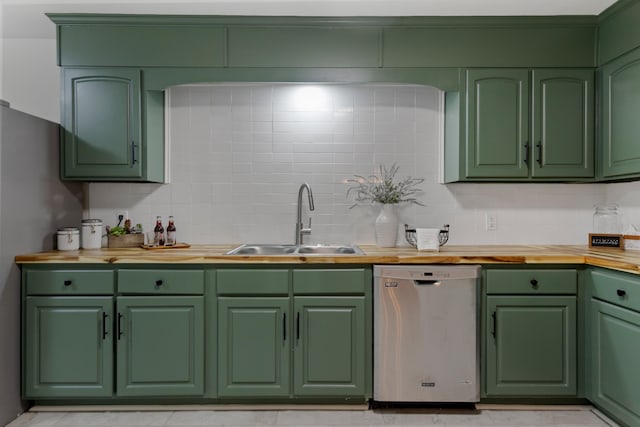 kitchen with green cabinetry, sink, stainless steel appliances, and wooden counters