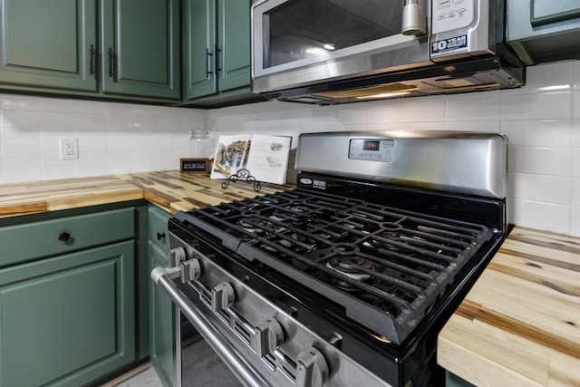 kitchen with stainless steel appliances, butcher block countertops, and green cabinetry