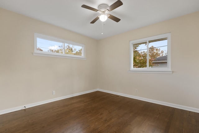 unfurnished room with ceiling fan and dark hardwood / wood-style flooring