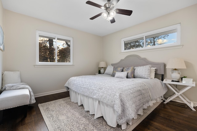 bedroom with dark hardwood / wood-style flooring and ceiling fan