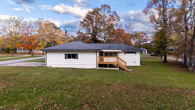 rear view of property featuring a yard