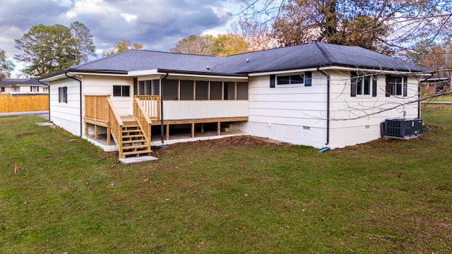 rear view of house with a sunroom, central air condition unit, a yard, and a wooden deck