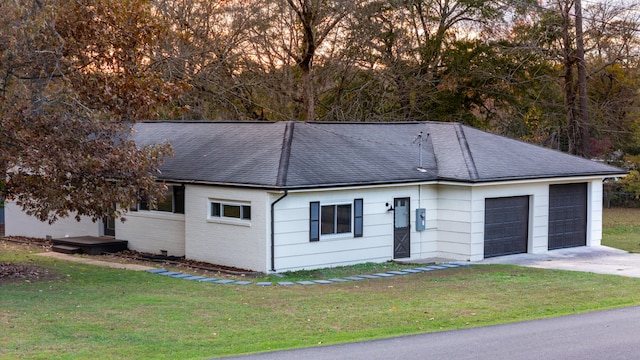 single story home featuring a garage and a front yard