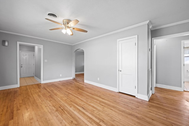 interior space featuring light hardwood / wood-style floors, ensuite bath, ceiling fan, and crown molding