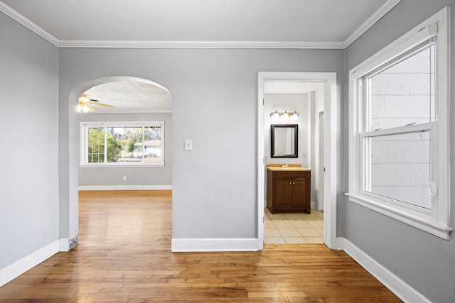 hall featuring light hardwood / wood-style floors and crown molding