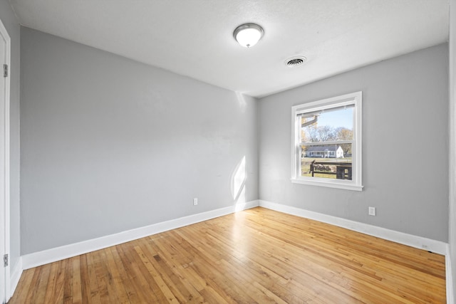 unfurnished room with wood-type flooring