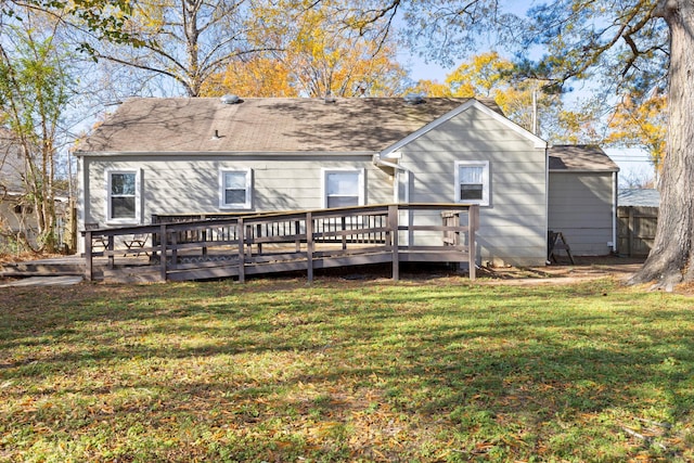 back of house featuring a wooden deck and a lawn