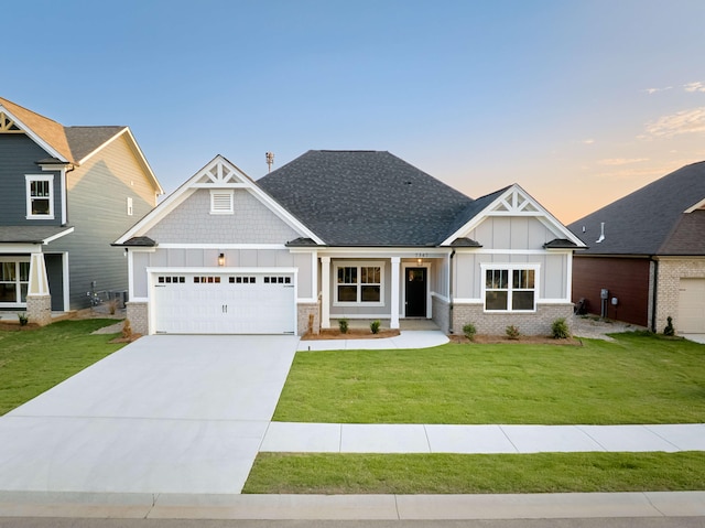 craftsman-style home featuring a garage and a lawn