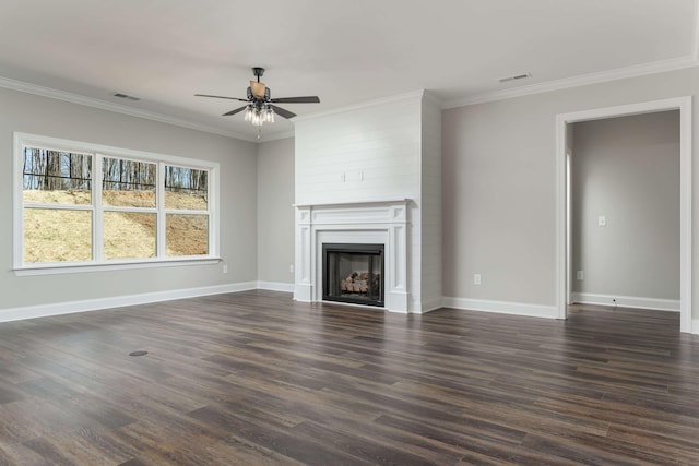 unfurnished living room featuring dark wood-type flooring, a large fireplace, and crown molding