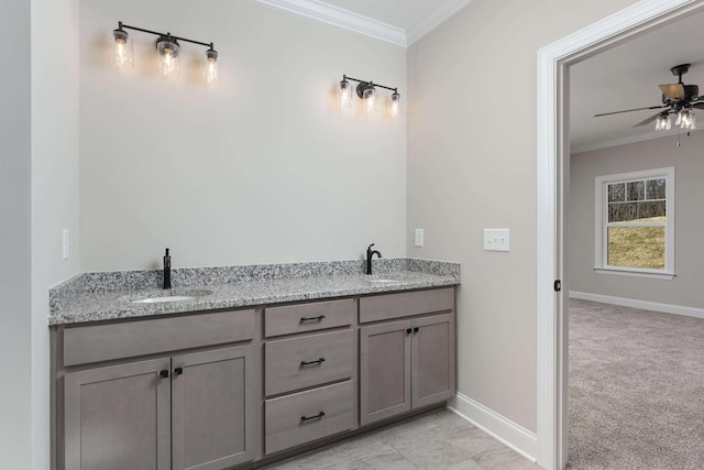 bathroom with ornamental molding, vanity, and ceiling fan