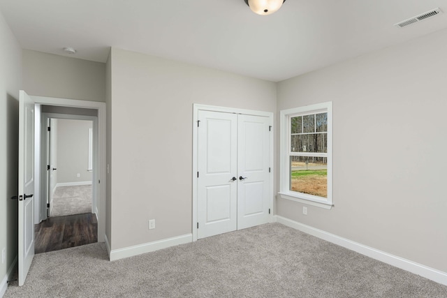 unfurnished bedroom featuring a closet and carpet