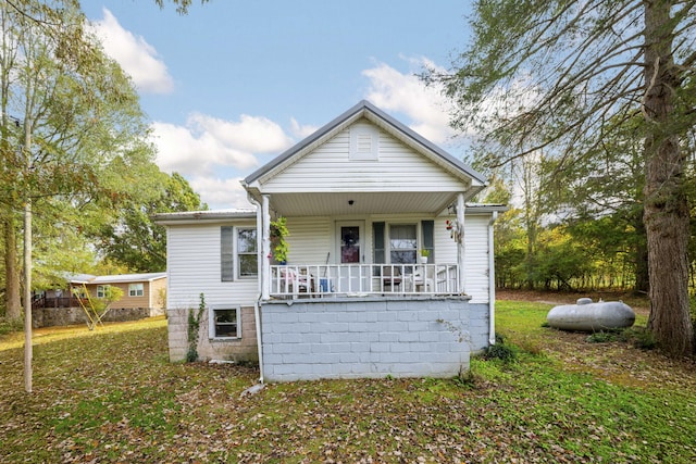 view of front of house with a front yard and a porch