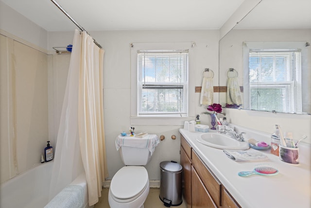 full bathroom with a wealth of natural light, vanity, toilet, and shower / bathtub combination with curtain