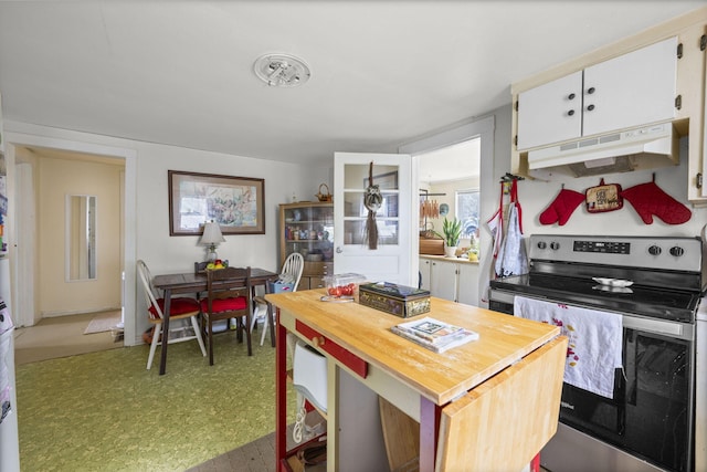 kitchen with a kitchen bar, white cabinetry, a kitchen island, and electric range