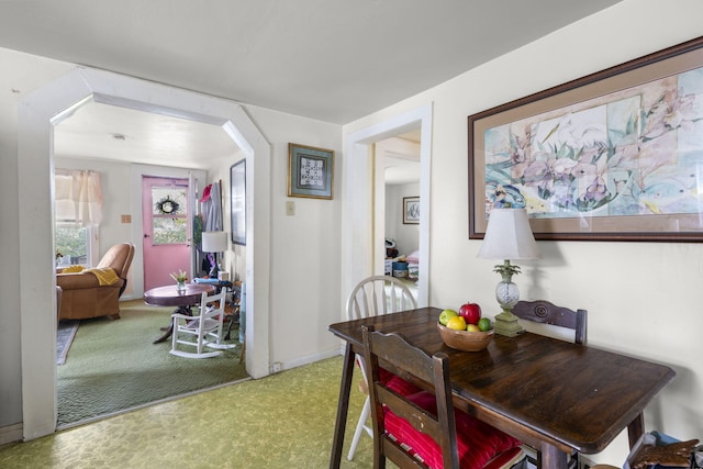 dining space featuring light carpet