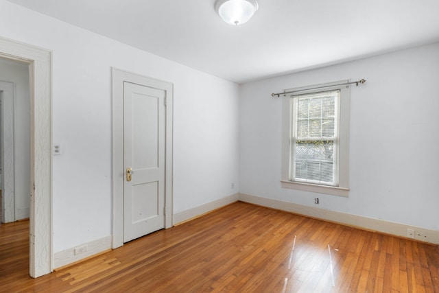 empty room with hardwood / wood-style floors