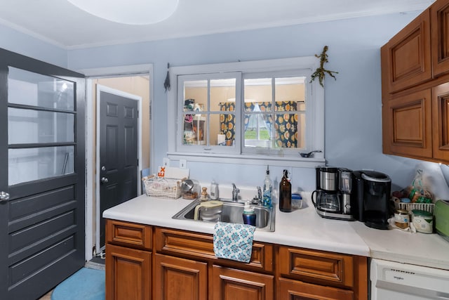 kitchen featuring dishwasher, ornamental molding, and sink