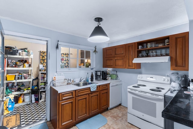 kitchen featuring pendant lighting, white appliances, and sink