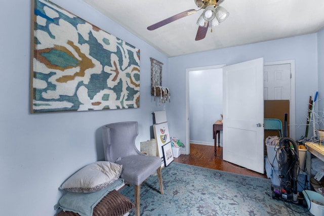 living area with hardwood / wood-style floors and ceiling fan