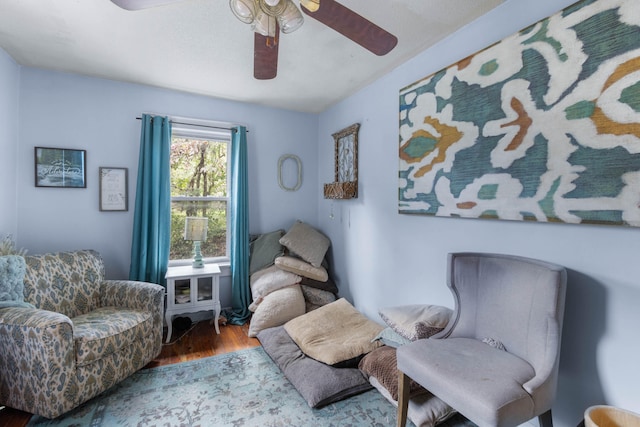 sitting room featuring ceiling fan and wood-type flooring