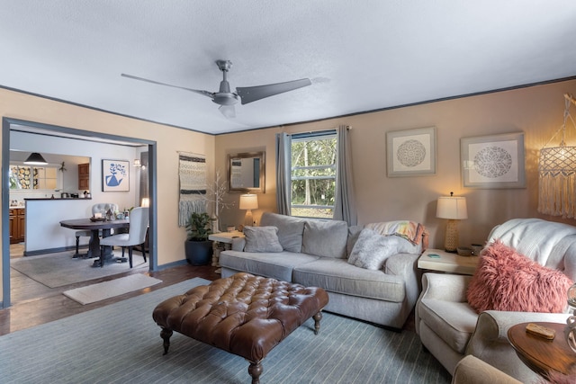 living room featuring dark wood-type flooring and ceiling fan