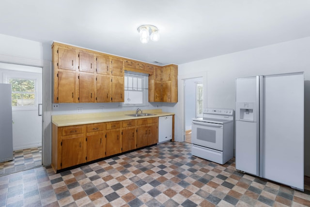 kitchen with sink and white appliances