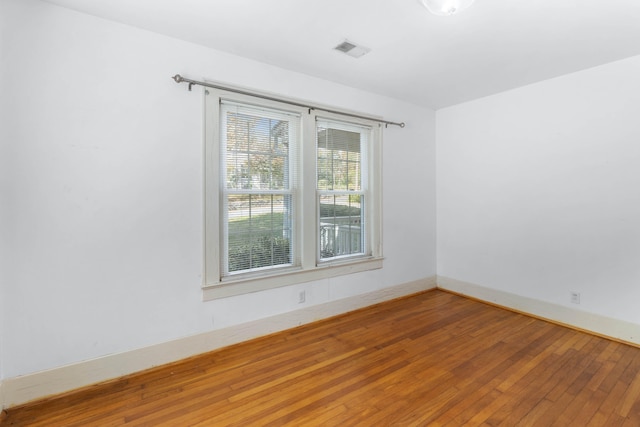 unfurnished room with hardwood / wood-style floors