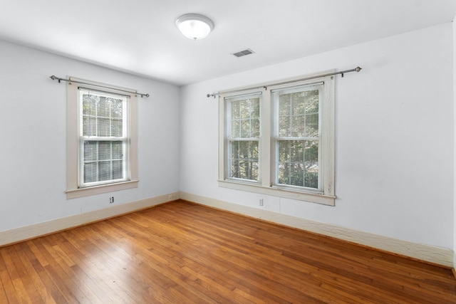 unfurnished room featuring hardwood / wood-style flooring