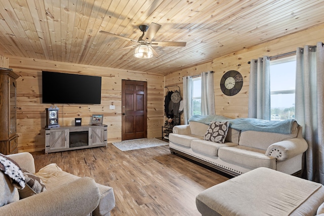 living room with hardwood / wood-style floors, a wealth of natural light, wooden walls, and wooden ceiling