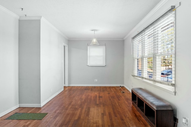 spare room with dark hardwood / wood-style floors and crown molding