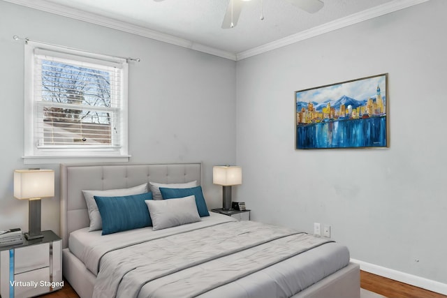 bedroom with hardwood / wood-style floors, ceiling fan, and crown molding