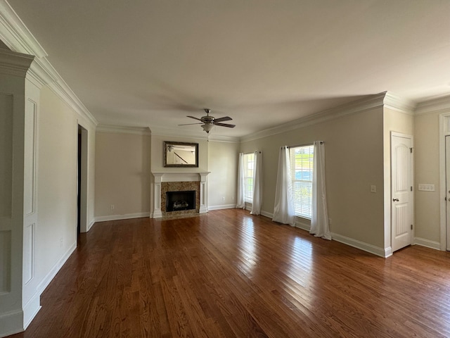 unfurnished living room with dark hardwood / wood-style flooring, ceiling fan, and ornamental molding