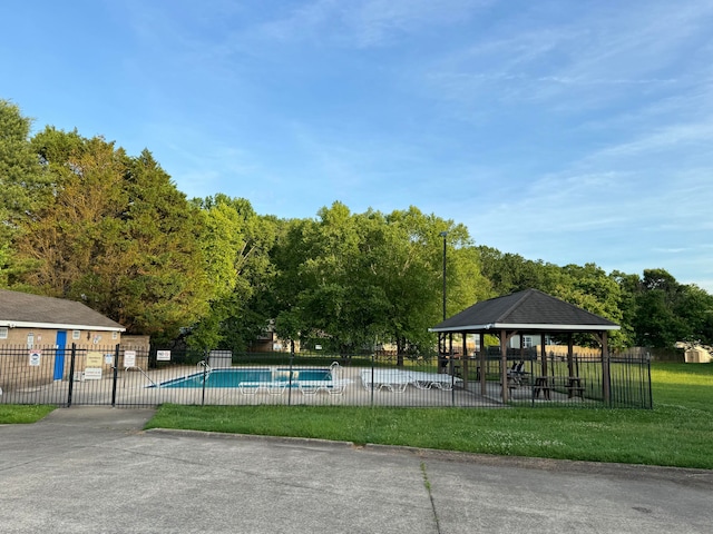 view of swimming pool featuring a gazebo and a yard