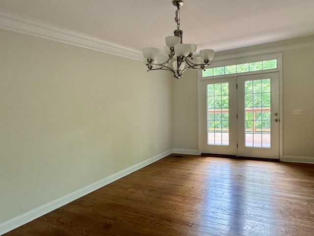 interior space featuring wood-type flooring, a notable chandelier, and ornamental molding