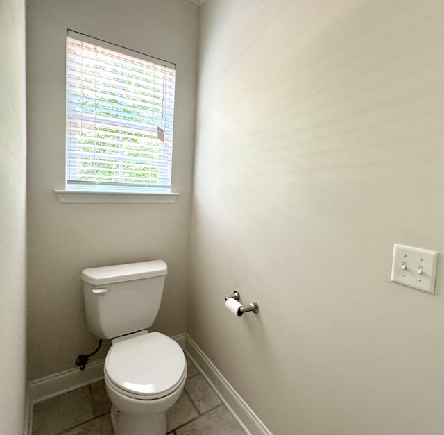 bathroom featuring tile patterned flooring and toilet