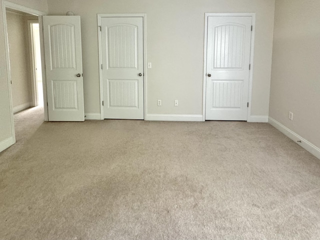 unfurnished bedroom featuring light carpet