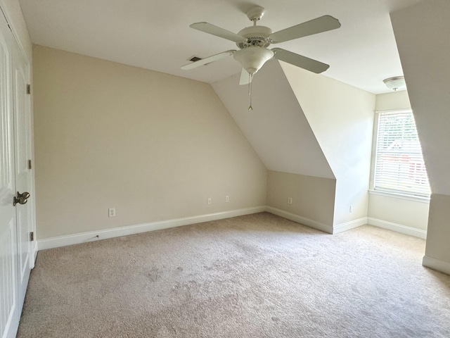 bonus room featuring ceiling fan, lofted ceiling, and light carpet