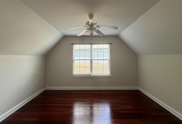 additional living space featuring dark hardwood / wood-style floors, vaulted ceiling, and ceiling fan