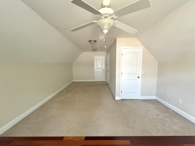 bonus room featuring ceiling fan, lofted ceiling, and light carpet