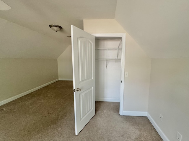 bonus room featuring lofted ceiling and light carpet