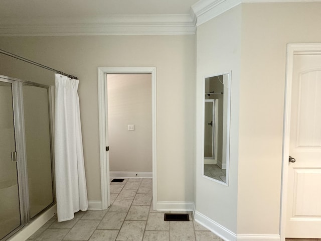 bathroom featuring ornamental molding and a shower with door