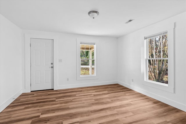 spare room with hardwood / wood-style flooring