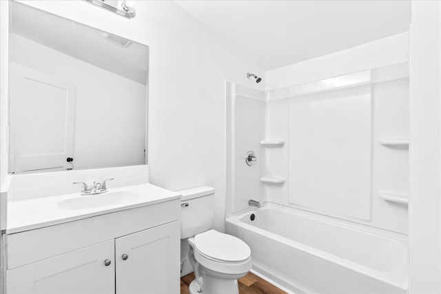 full bathroom featuring hardwood / wood-style floors, tub / shower combination, toilet, and vanity