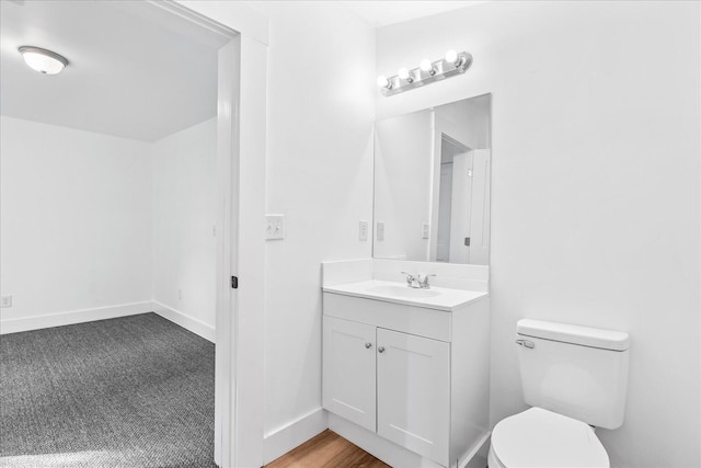 bathroom featuring hardwood / wood-style floors, vanity, and toilet